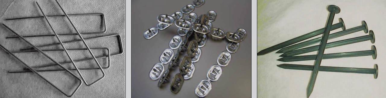 Set of metal fixing accessories including staples, cable clips with nails, and large green nails on fabric background